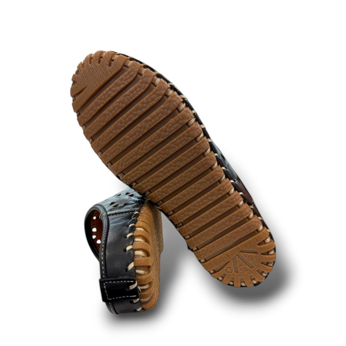 Roamers black leather slip-on mules with perforated cutouts and contrast stitching on a rubber sole.
photo of the bottom side