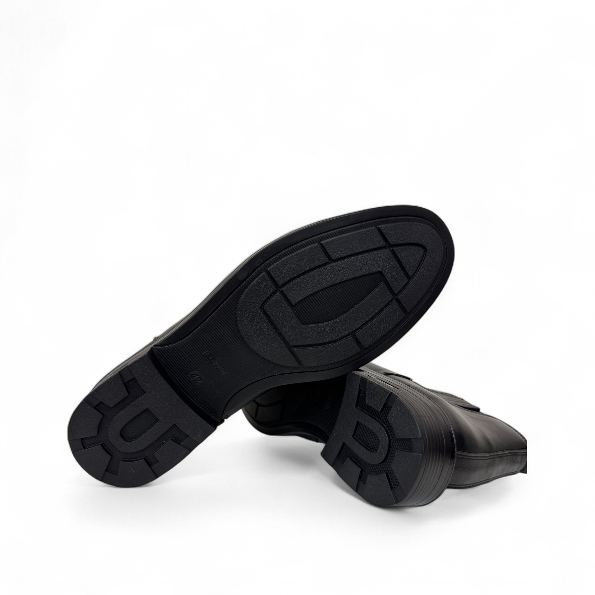 Satel Mashhad black leather boots with brogue detailing and elastic side panels on a white background. Photo of bottom view.