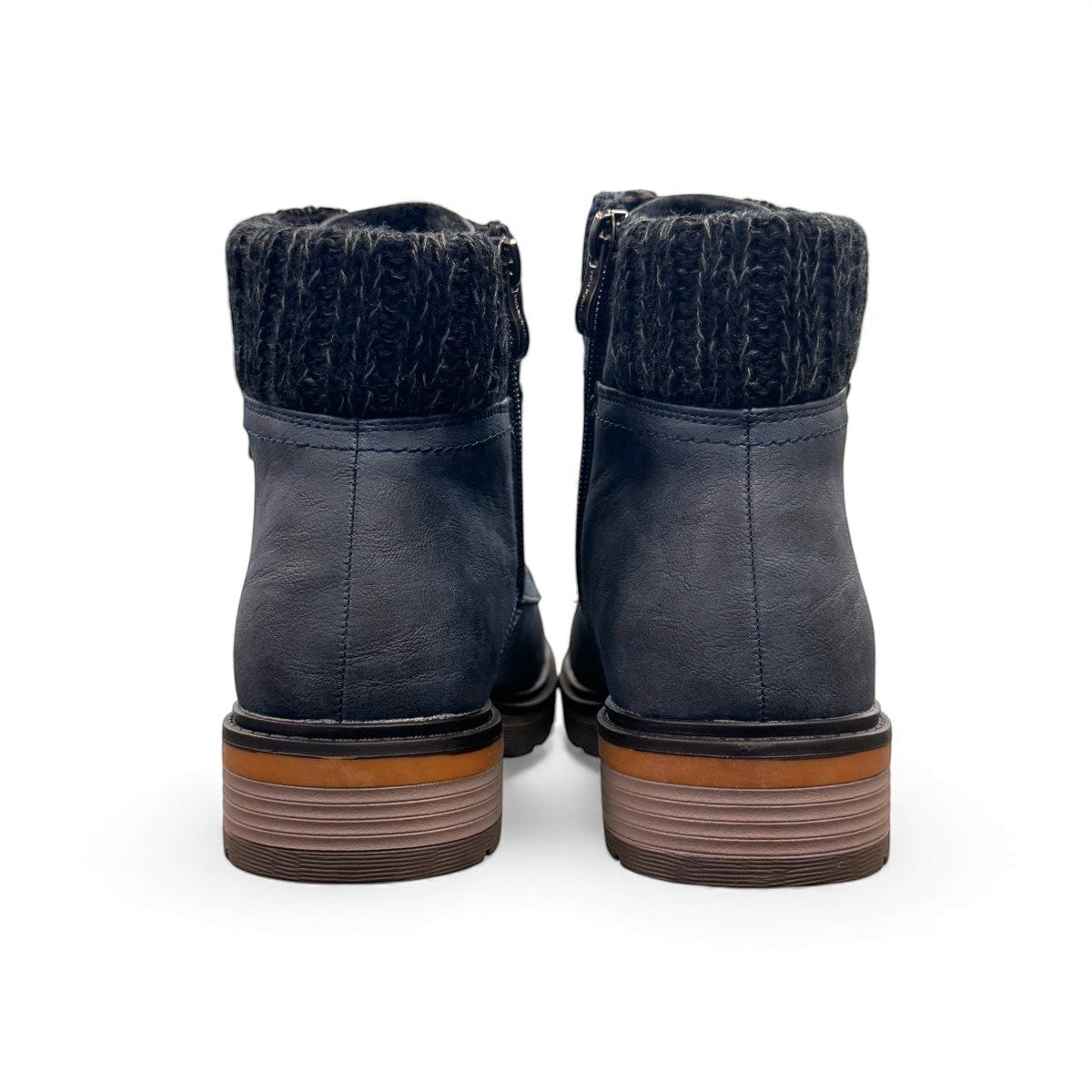Wanderlust navy ankle boot with faux leather, chunky knit cuff, side zipper, lace-up closure, and lugged sole.