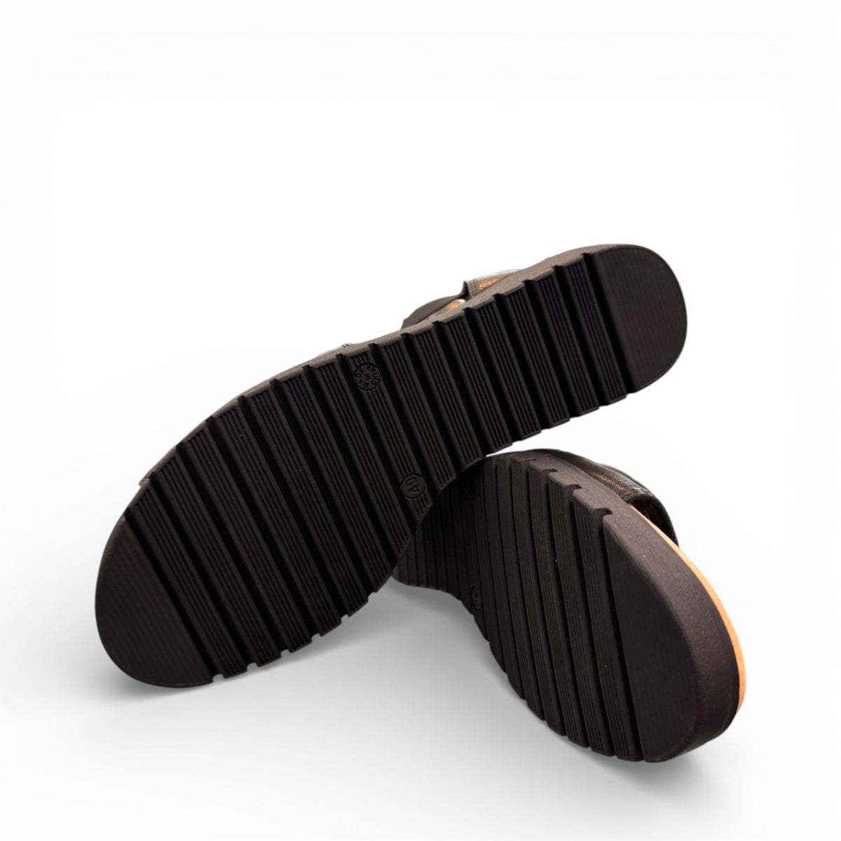 Django & Juliette Montaen black leather platform wedge sandals with laser-cut detailing and ankle strap. Photo of bottom view.