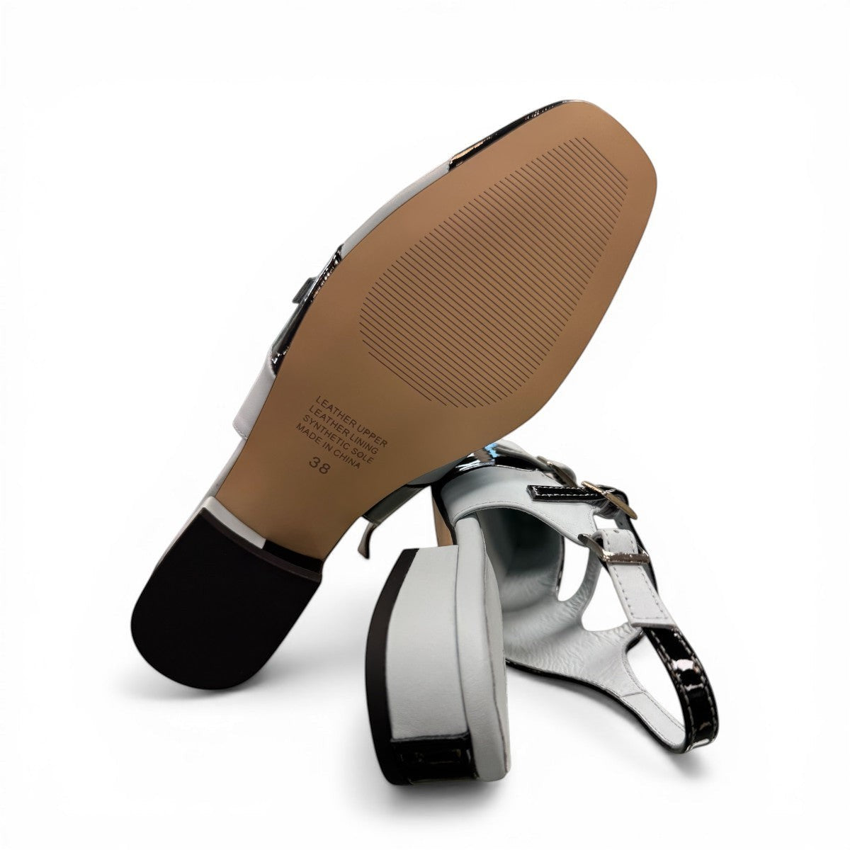DJANGO & JULIETTE Brynns black and white patent leather slingback Mary Jane flat with buckled straps.
bottom view.