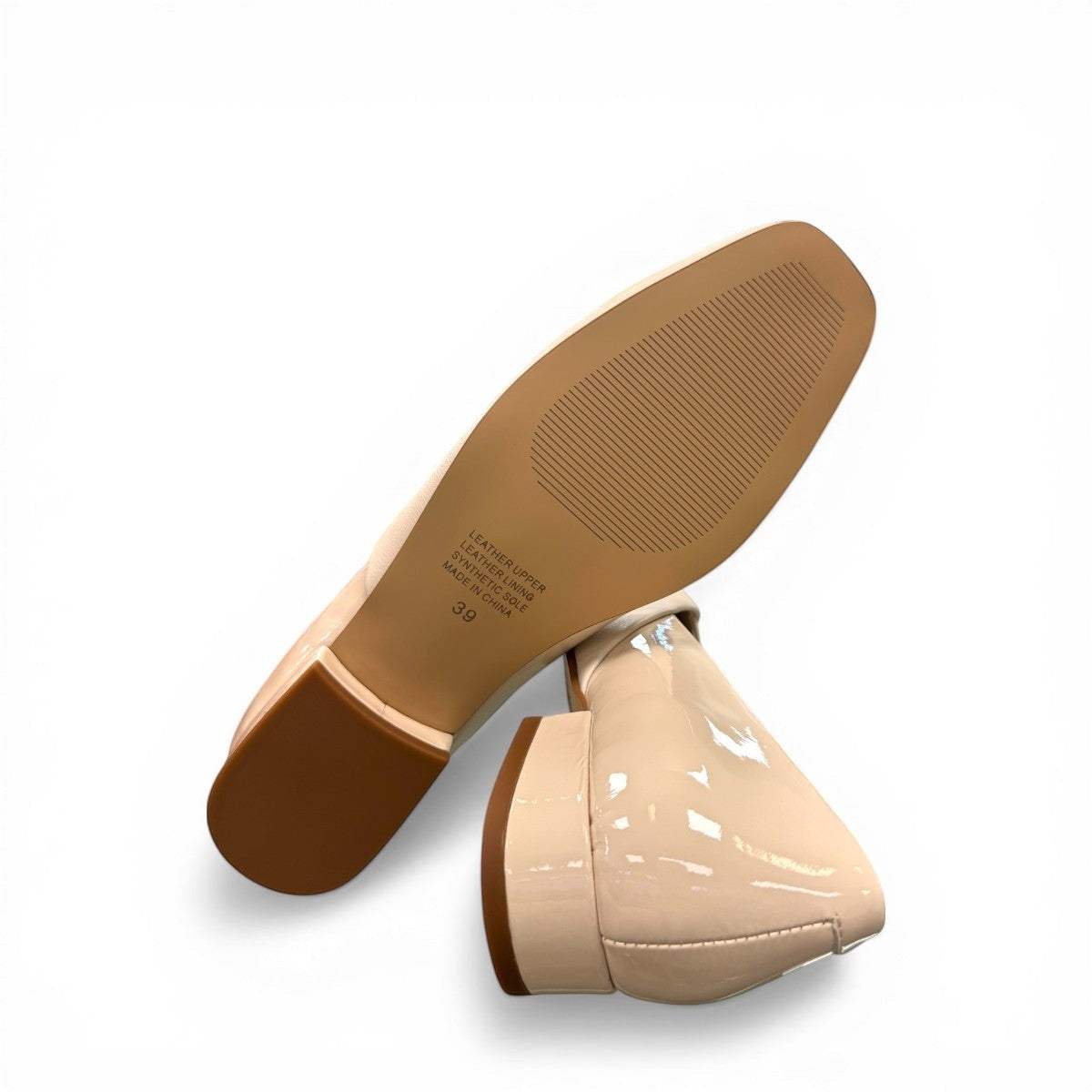 DJANGO & JULIETTE ivory leather and patent block heel pump with a rounded toe and slip-on design. bottom view.