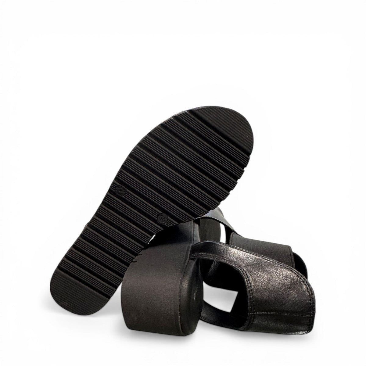 Django & Juliette Ozie black leather wedge sandal with elastic straps and a 2-inch platform sole. bottom view.