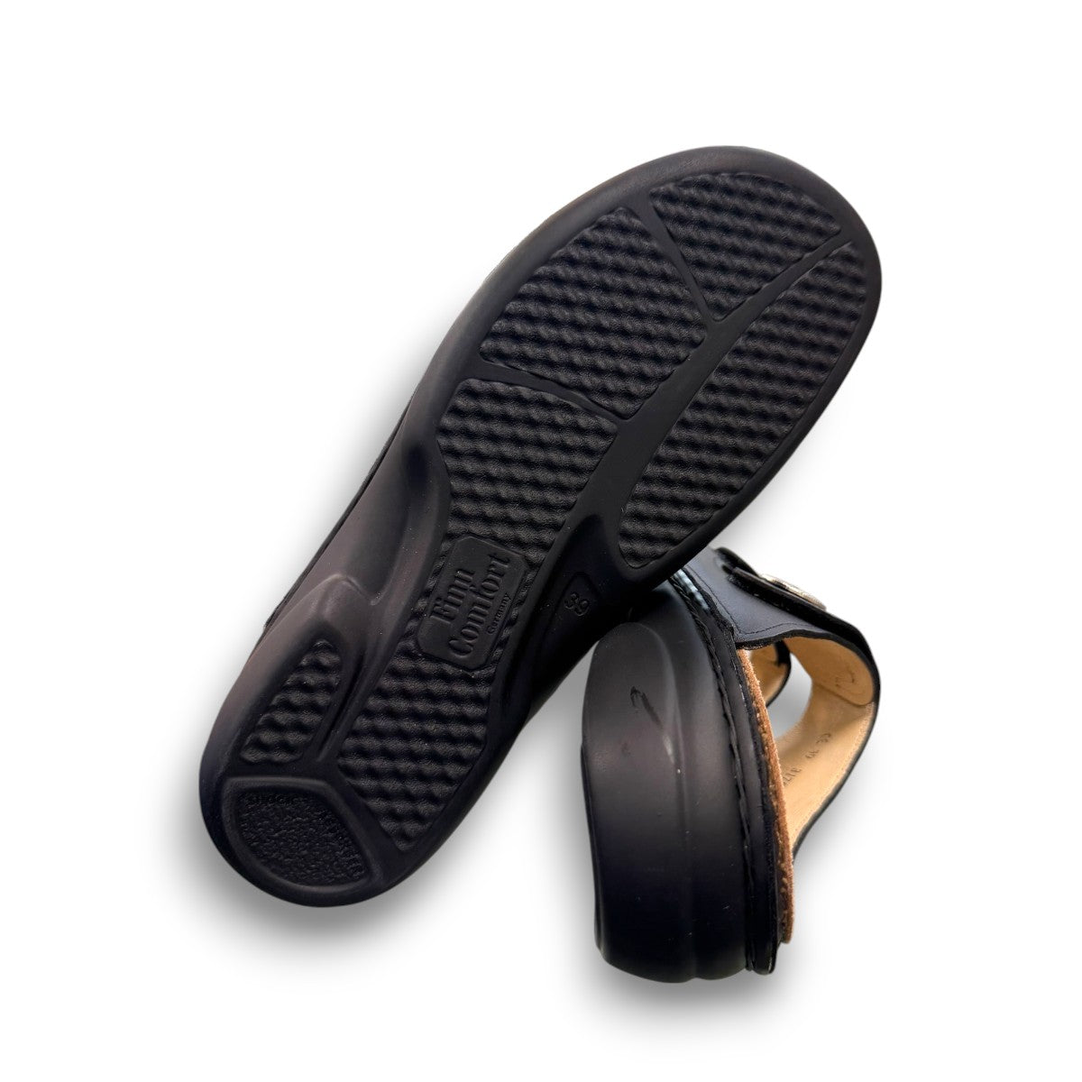 Finn Comfort Sansibar black leather sandal with two adjustable straps and decorative silver button.
photo of the bottom side