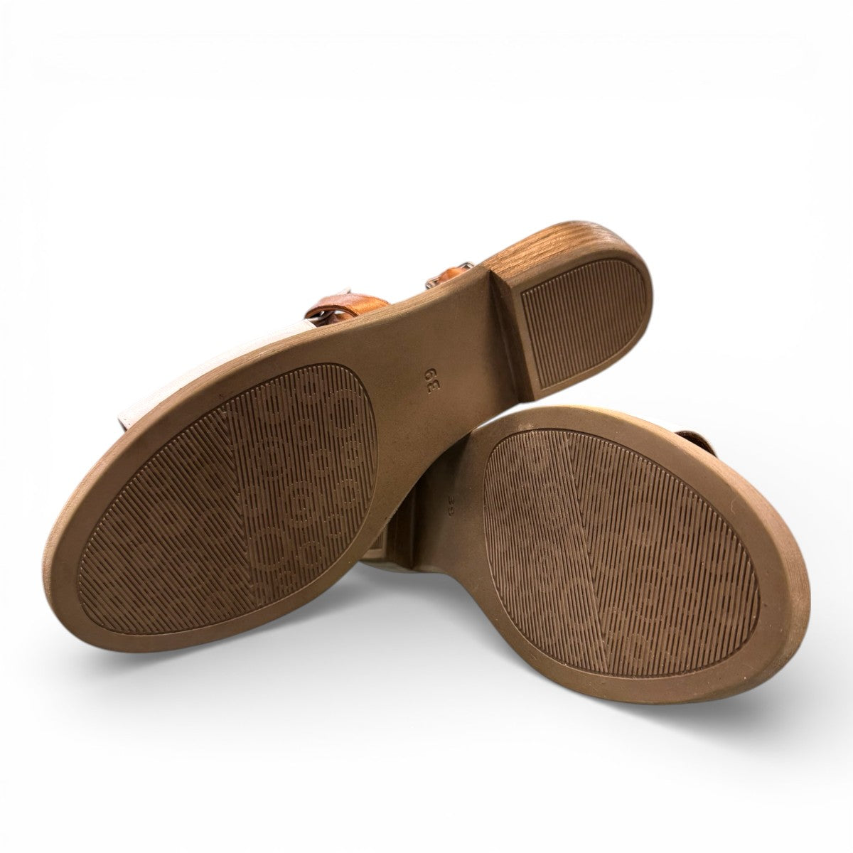roamers Jude low heel sandal in white coconut leather with a brown side buckle strap and stacked heel.
photo of the bottom side