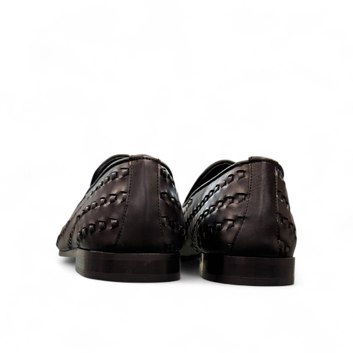 Sun Roniya black leather loafers featuring intricate handmade woven detailing and a rubber outsole. Photo of back view.
