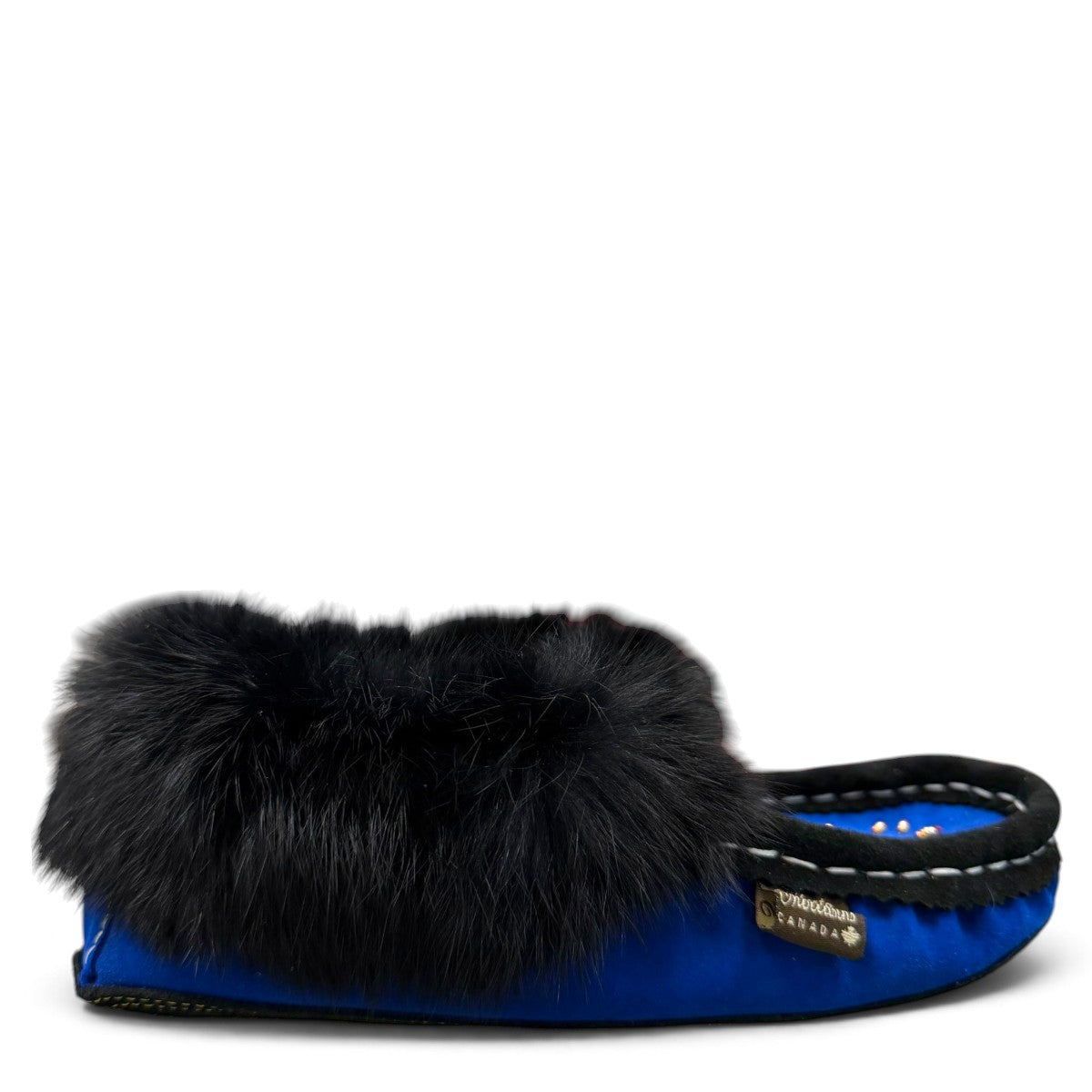 Alberta blue suede moccasin with a black rabbit fur ankle collar, handcrafted for cozy indoor comfort. Photo of right side view.