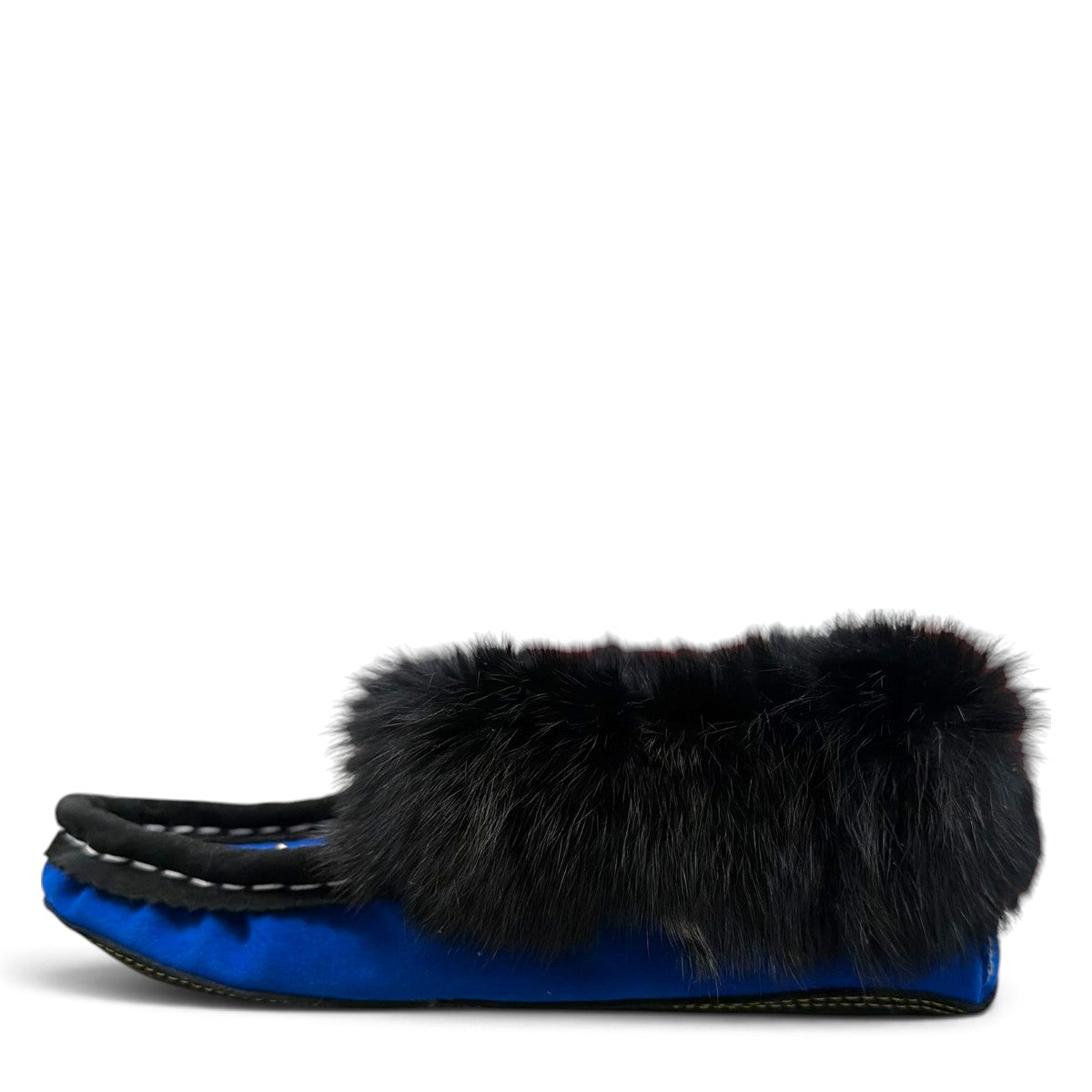 Alberta blue suede moccasin with a black rabbit fur ankle collar, handcrafted for cozy indoor comfort. Photo of left side view.