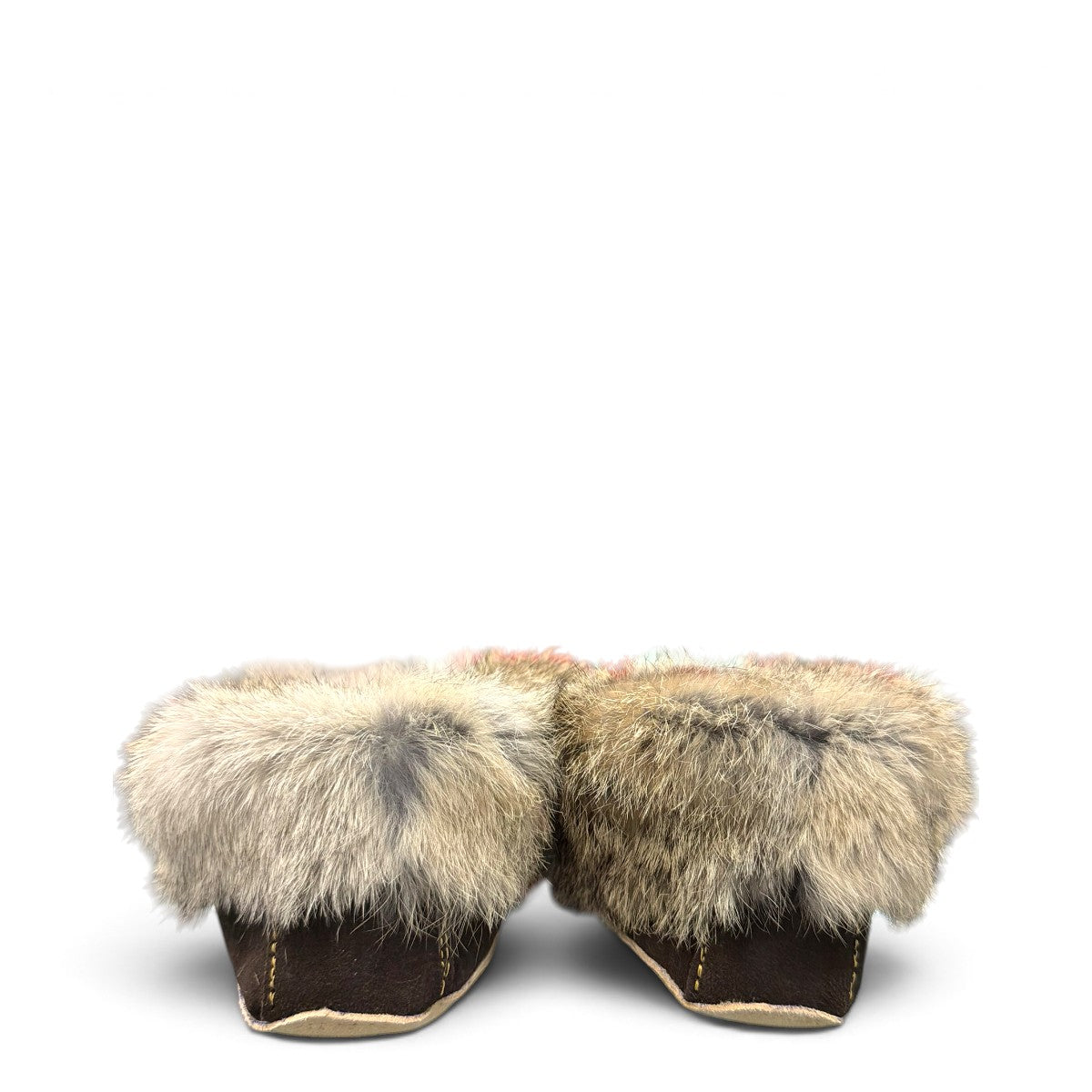 Alberta brown suede moccasin with cream trim and fluffy rabbit fur ankle collar, side view. Photo of back view.