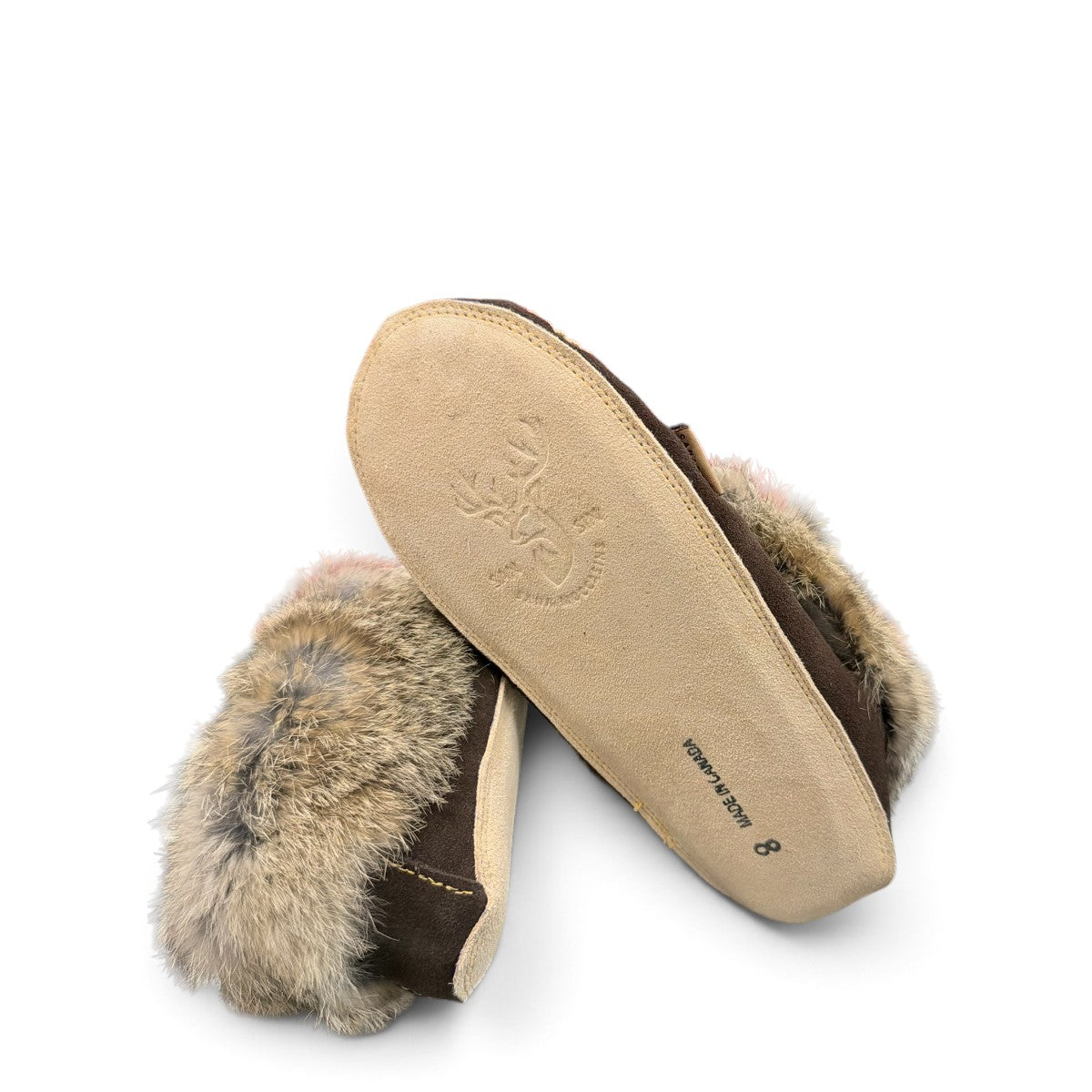 Alberta brown suede moccasin with cream trim and fluffy rabbit fur ankle collar, side view. Photo of bottom view.