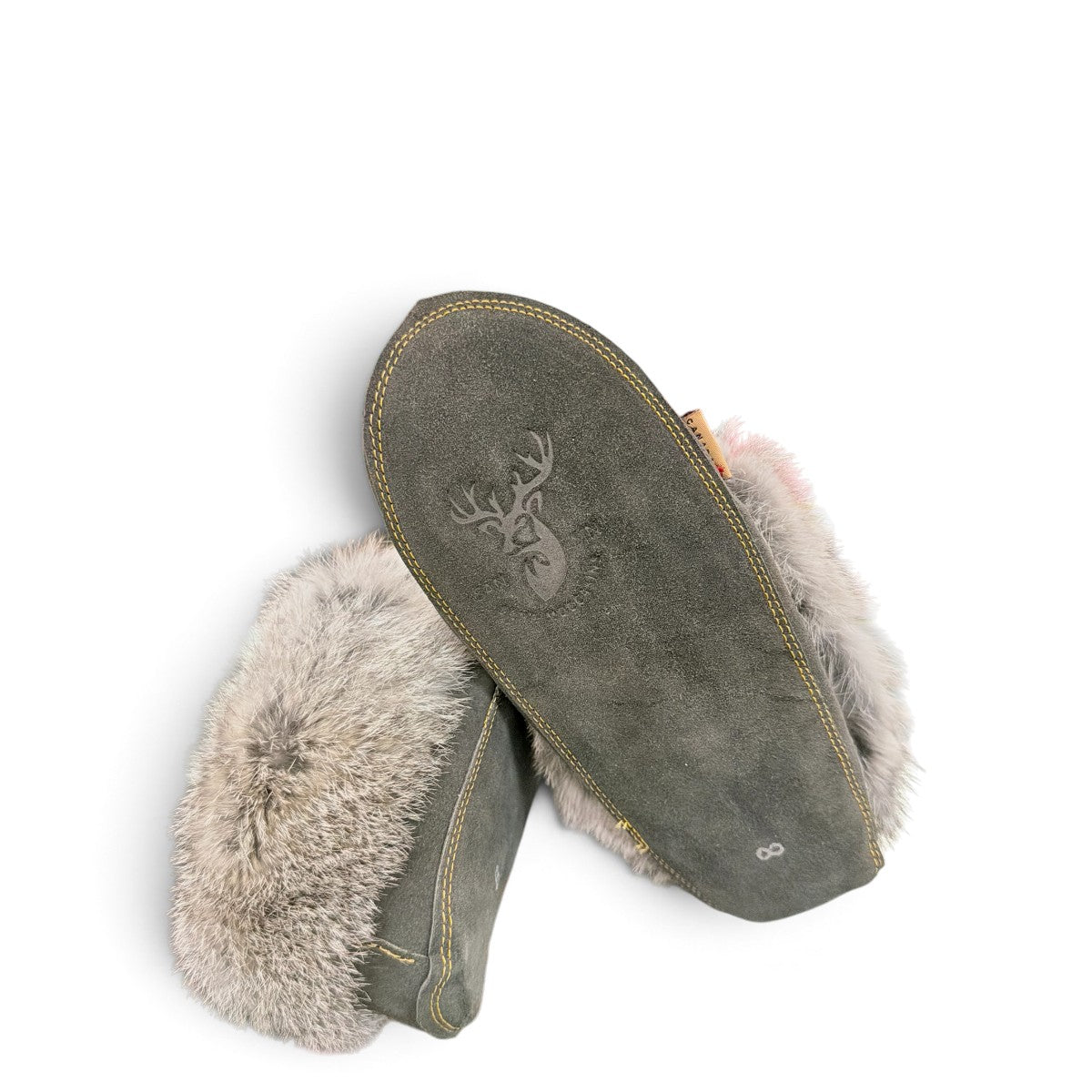 Alberta grey suede moccasins with a plush rabbit fur ankle collar and hand-stitched detailing. Photo of bottom view.