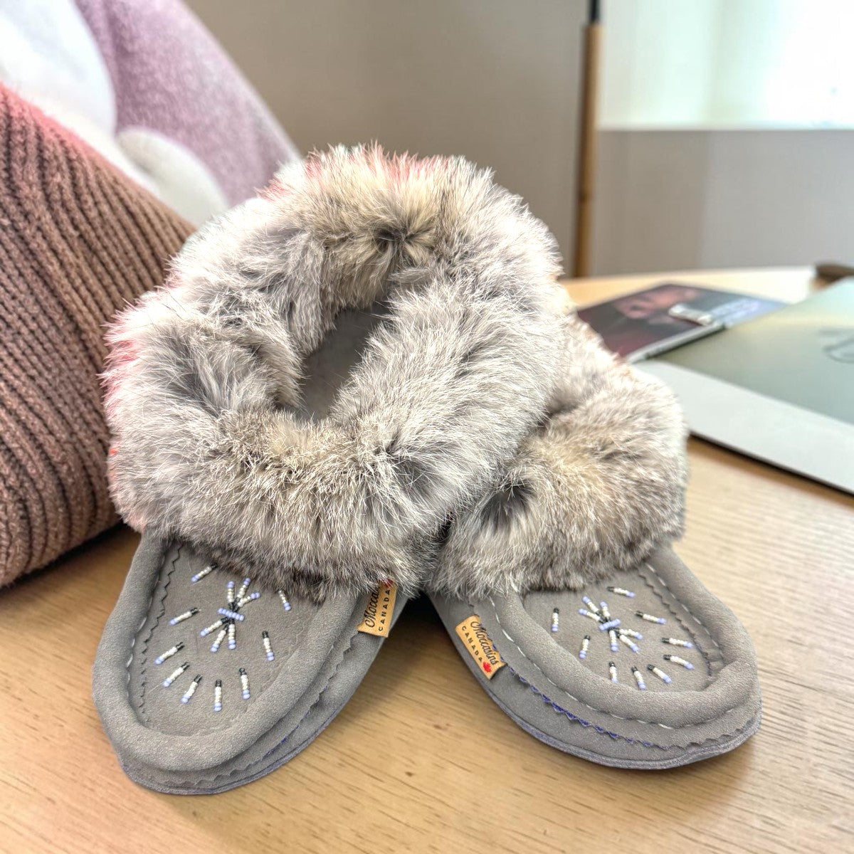 Alberta light grey suede moccasin with a fluffy rabbit fur ankle collar, handcrafted side view. Photo of front side view.