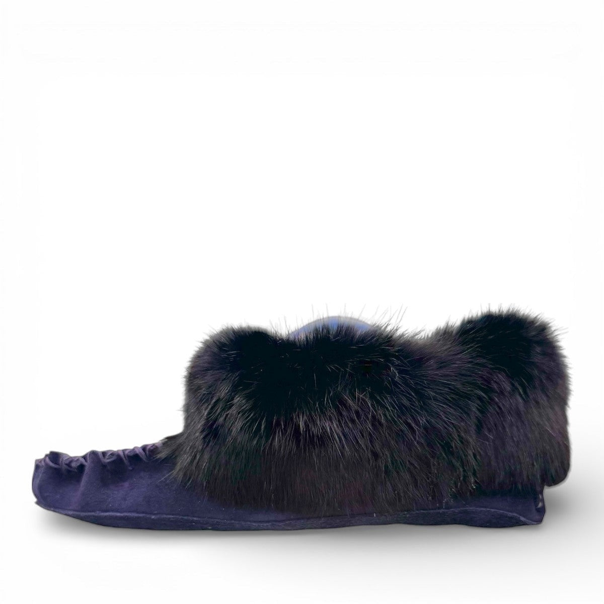 Alberta navy cowhide suede moccasins with a plush black rabbit fur ankle collar, handcrafted design.
photo of the left side