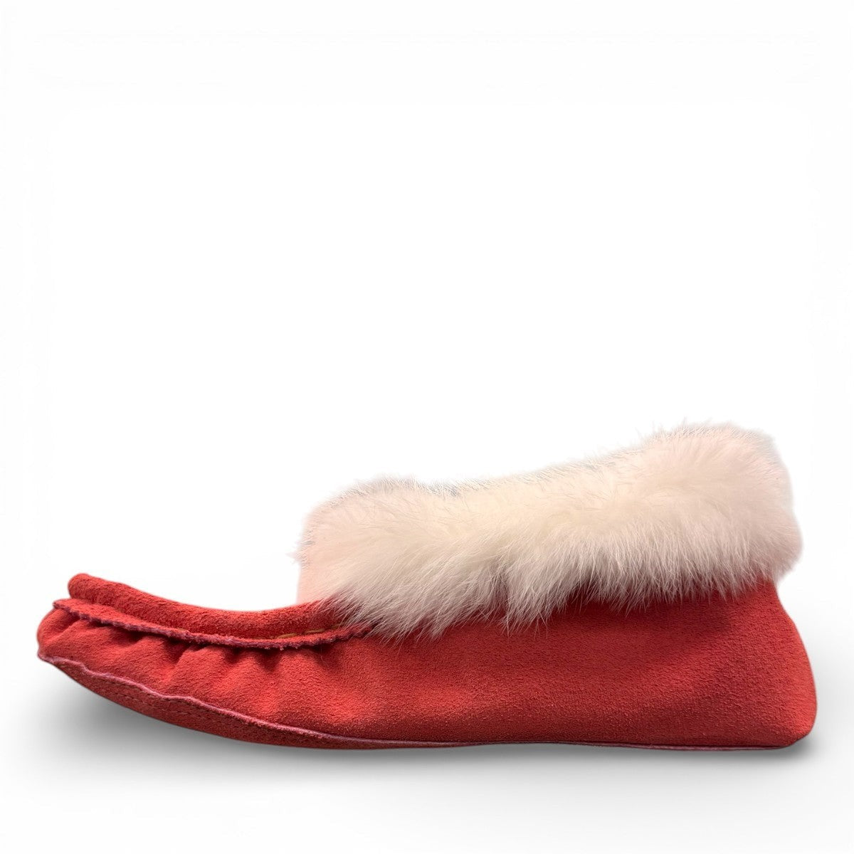 Alberta peach cowhide suede moccasins with a soft white rabbit fur ankle trim, handcrafted for cozy comfort.
photo of the left side