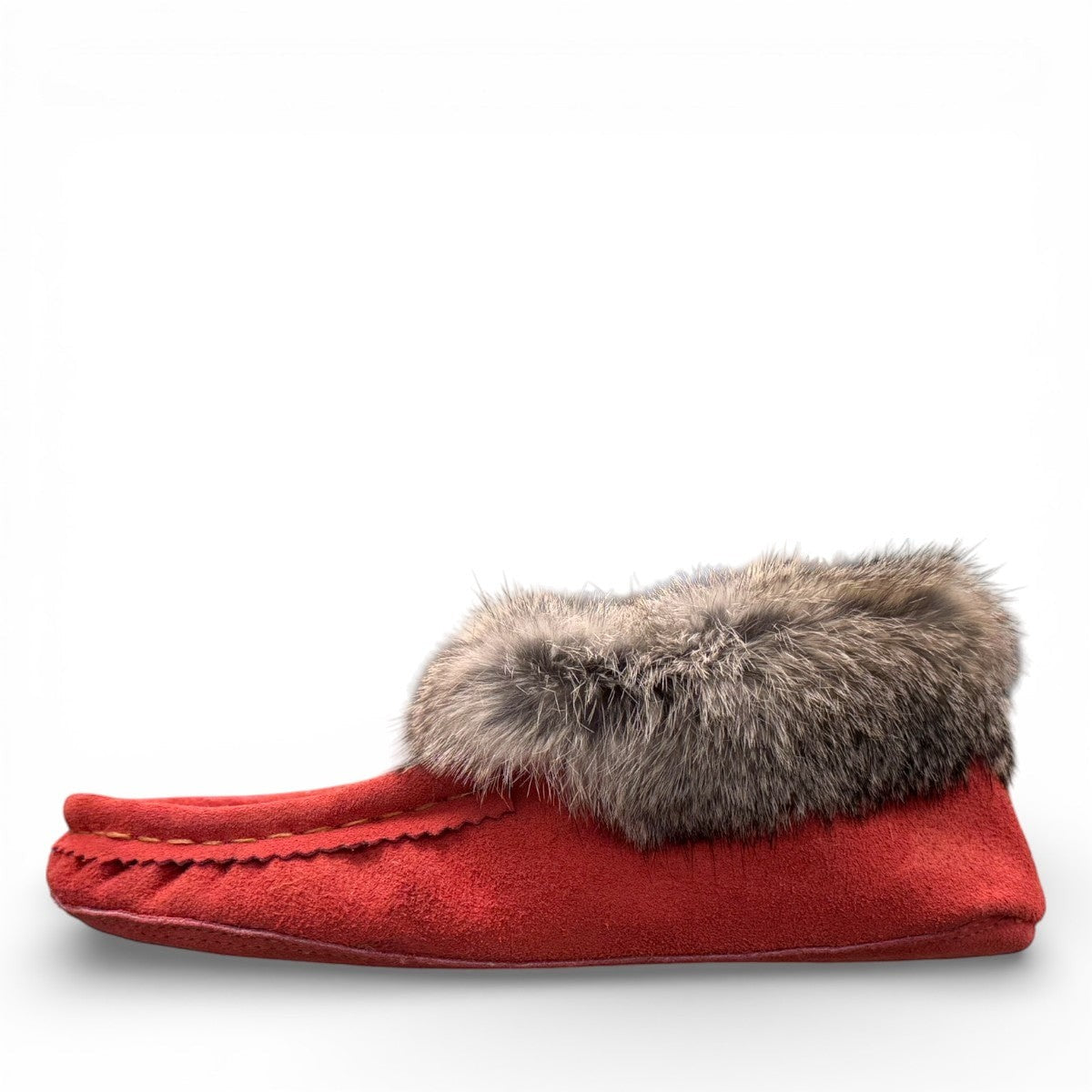Alberta  peach cowhide suede moccasins with a soft rabbit fur ankle collar, handcrafted for cozy indoor comfort.
photo of the left side