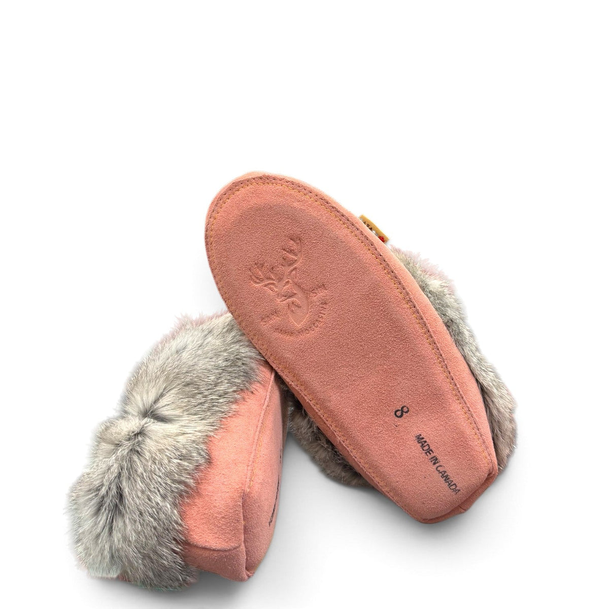 Alberta pink suede moccasins with a soft rabbit fur ankle collar, handcrafted for cozy comfort. Photo of bottom view.