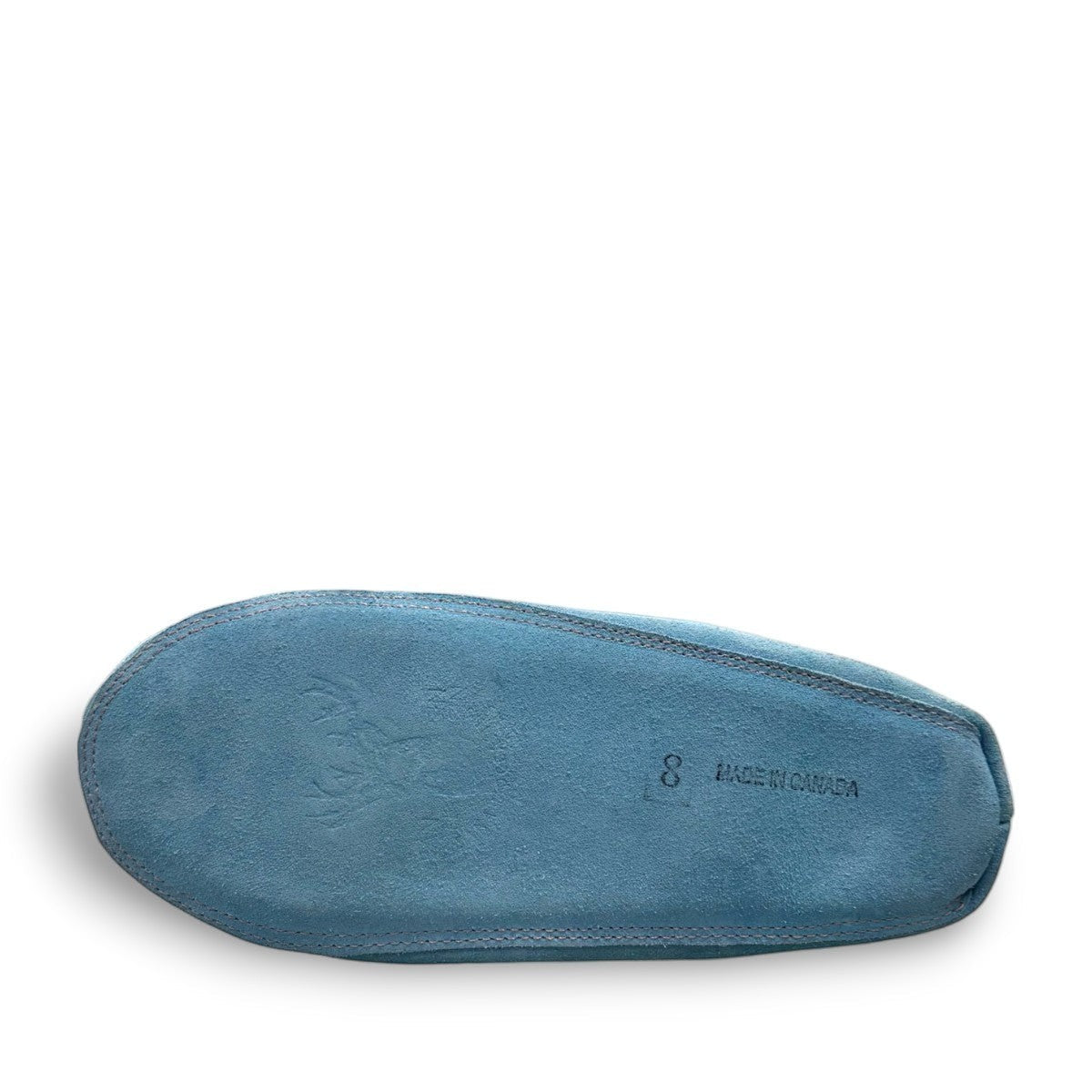 Alberta turquoise cowhide suede moccasins with a soft white rabbit fur ankle trim, handcrafted design.
photo of the bottom side