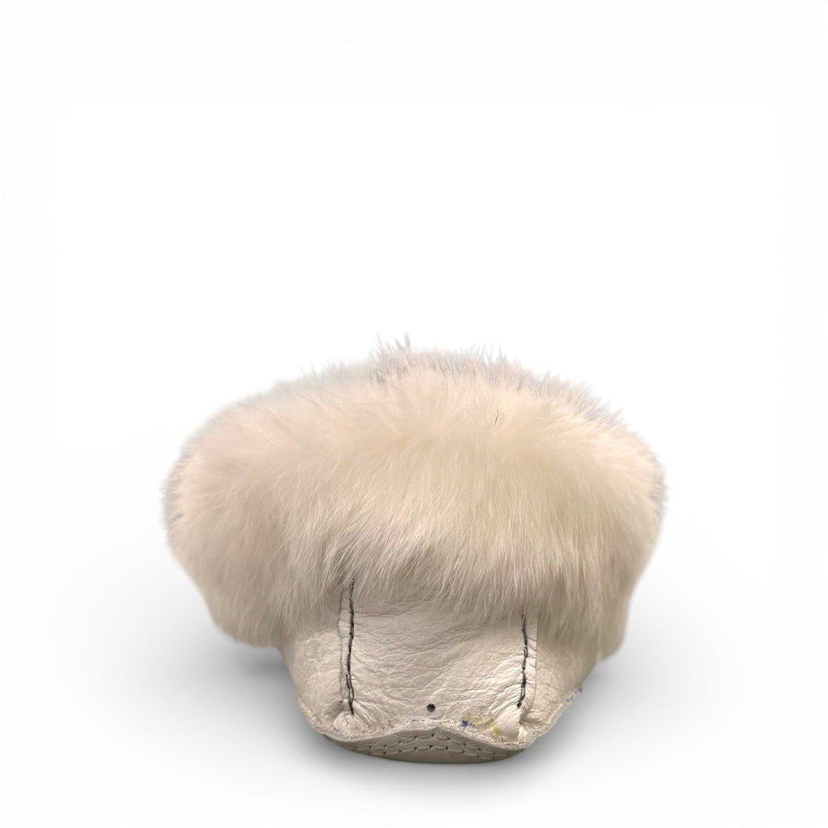 Alberta  white leather moccasins featuring a plush fur collar and side brand tag, side view.
photo of the back side