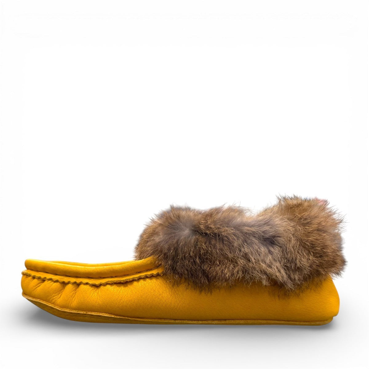 Alberta yellow deer skin leather moccasins with a soft rabbit fur ankle collar, handcrafted design.
photo of the left side