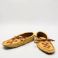 Alberta moccasins yellow caribou hide leather moccasins with a soft double leather sole and brown lace-up closure.
photo of the top side