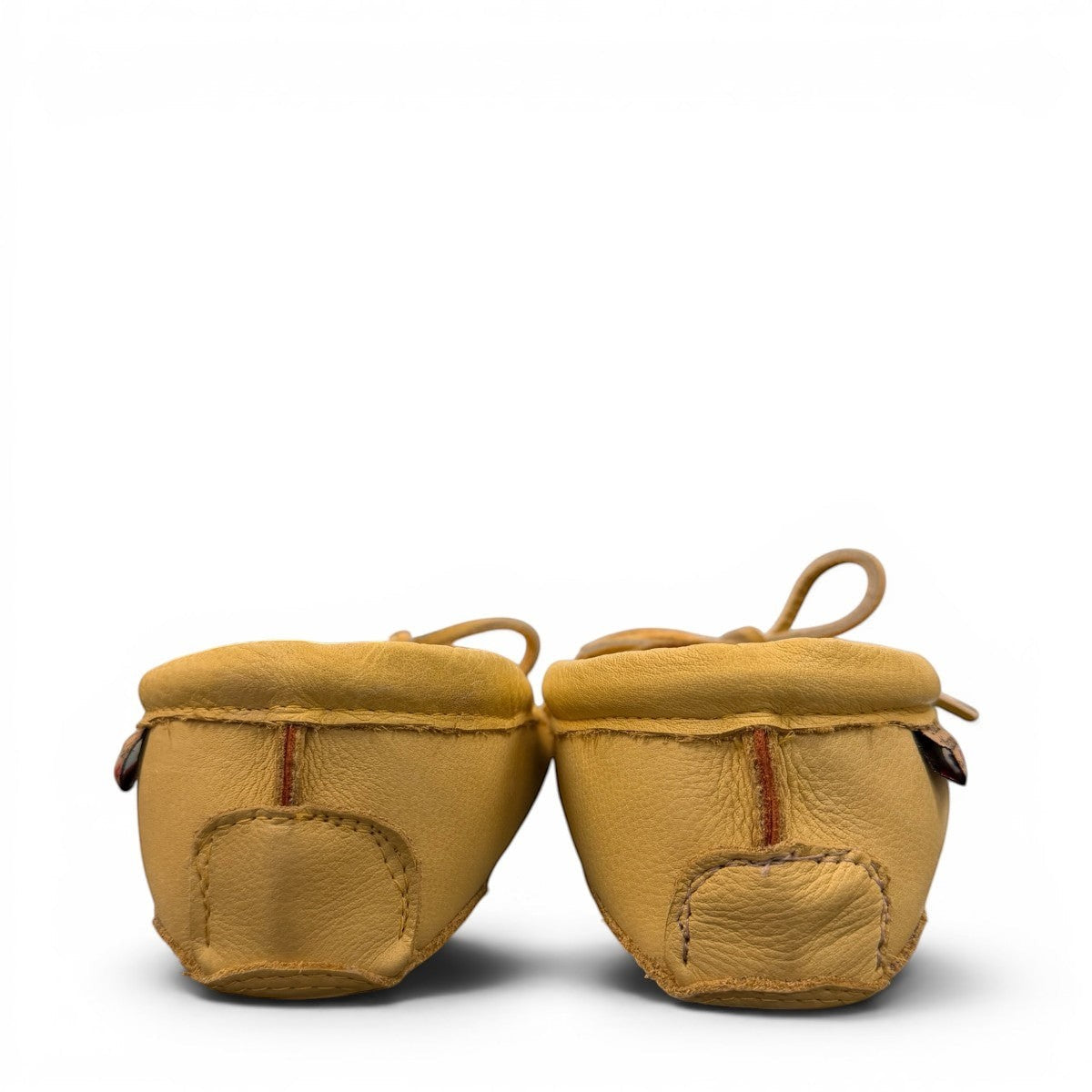 Alberta yellow genuine caribou hide leather moccasins with a soft double leather sole and lace-up front.
photo of the back side