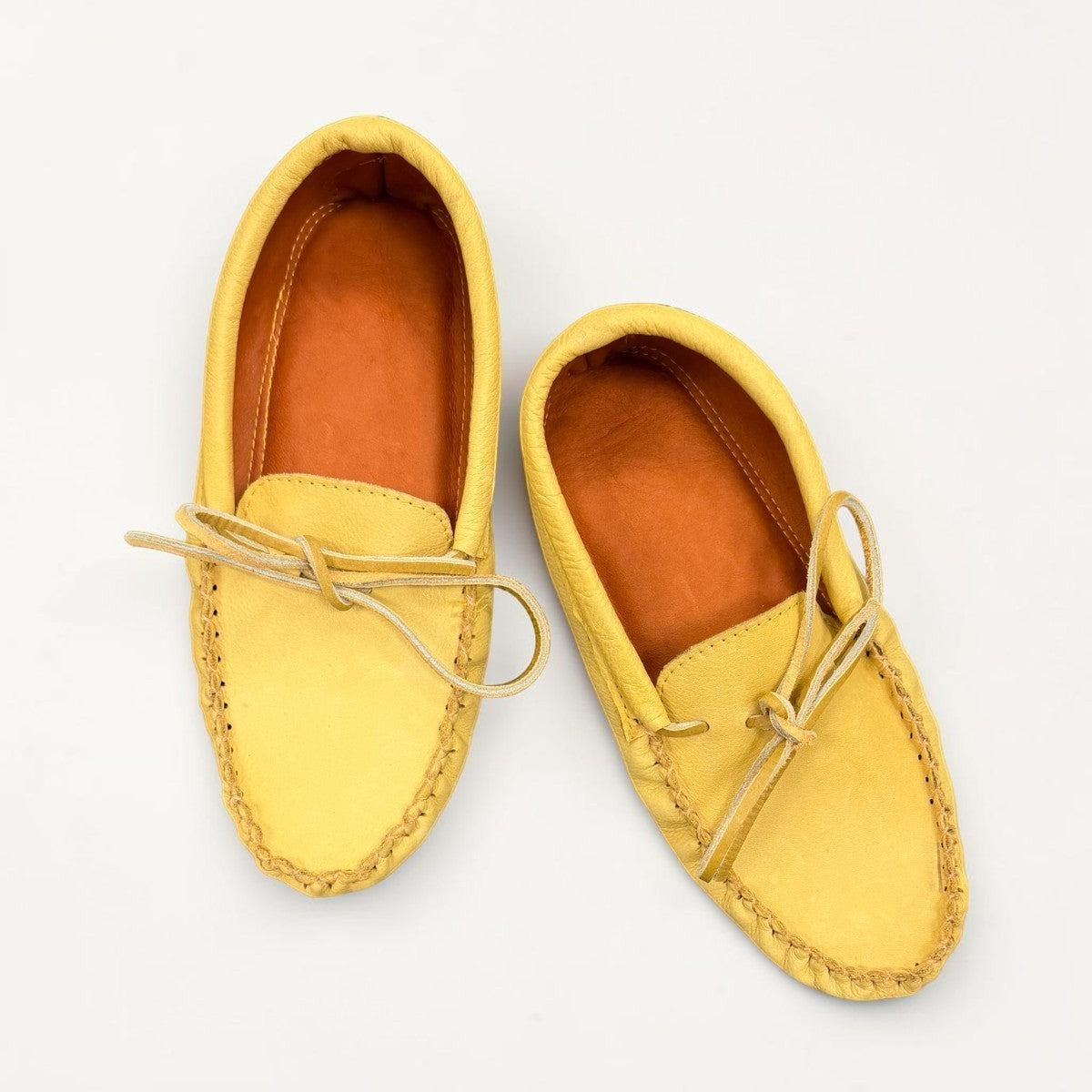 Alberta yellow genuine caribou hide leather moccasins with a soft double leather sole and lace-up front.
photo of the top side