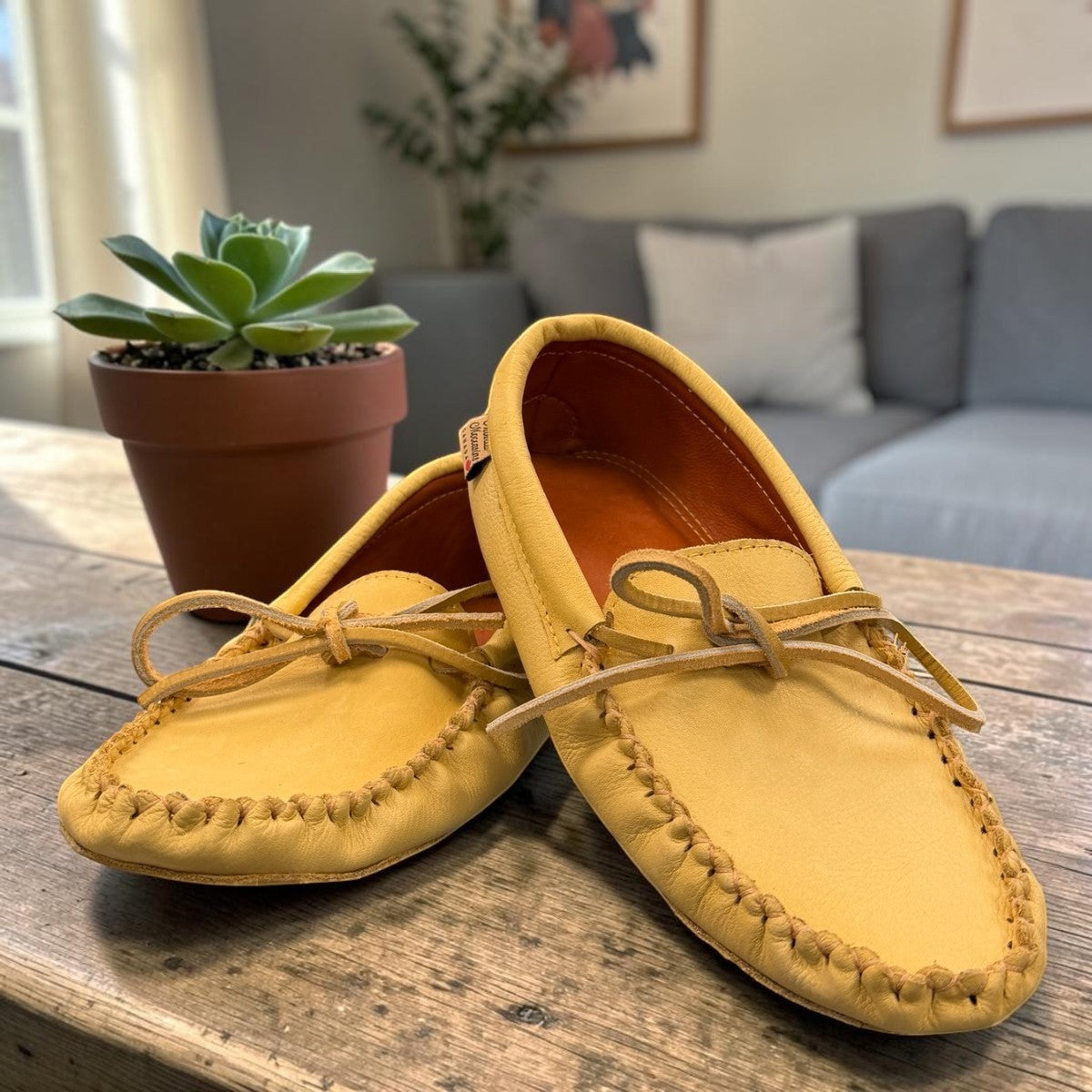 Alberta yellow genuine caribou hide leather moccasins with a soft double leather sole and lace-up front.
photo of the  front side