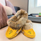Alberta yellow suede moccasins with rabbit fur trim, handcrafted leather slippers for cozy everyday wear. Photo of front side view.