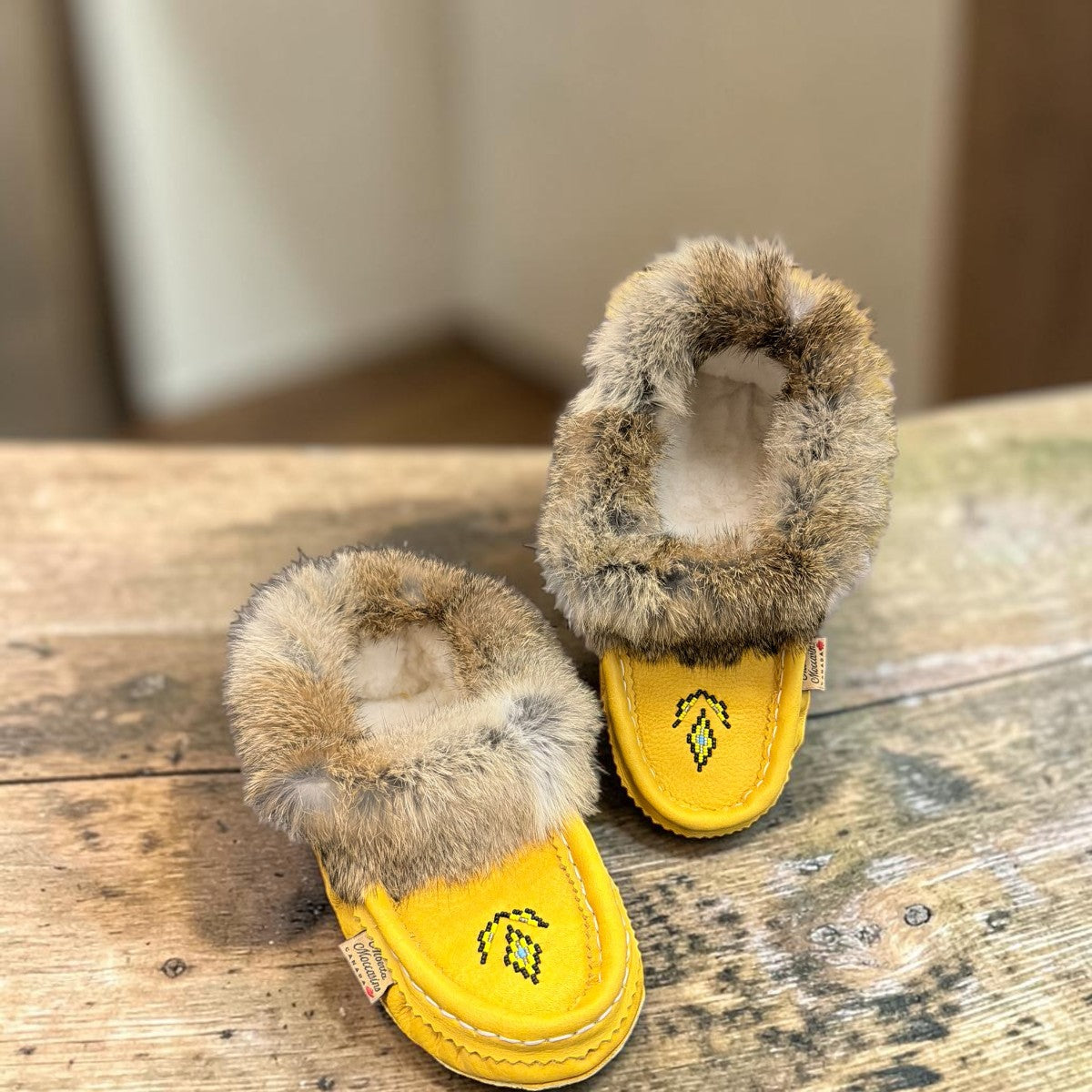 Alberta yellow suede moccasins with rabbit fur trim, handcrafted leather slippers for cozy everyday wear. Photo of upper view.