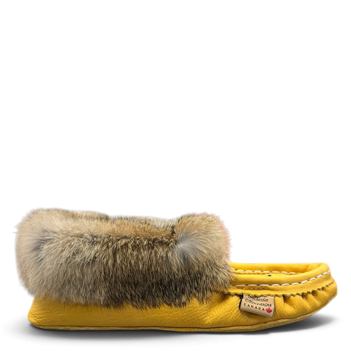 Alberta yellow suede moccasins with rabbit fur trim, handcrafted leather slippers for cozy everyday wear. Photo of right side view.