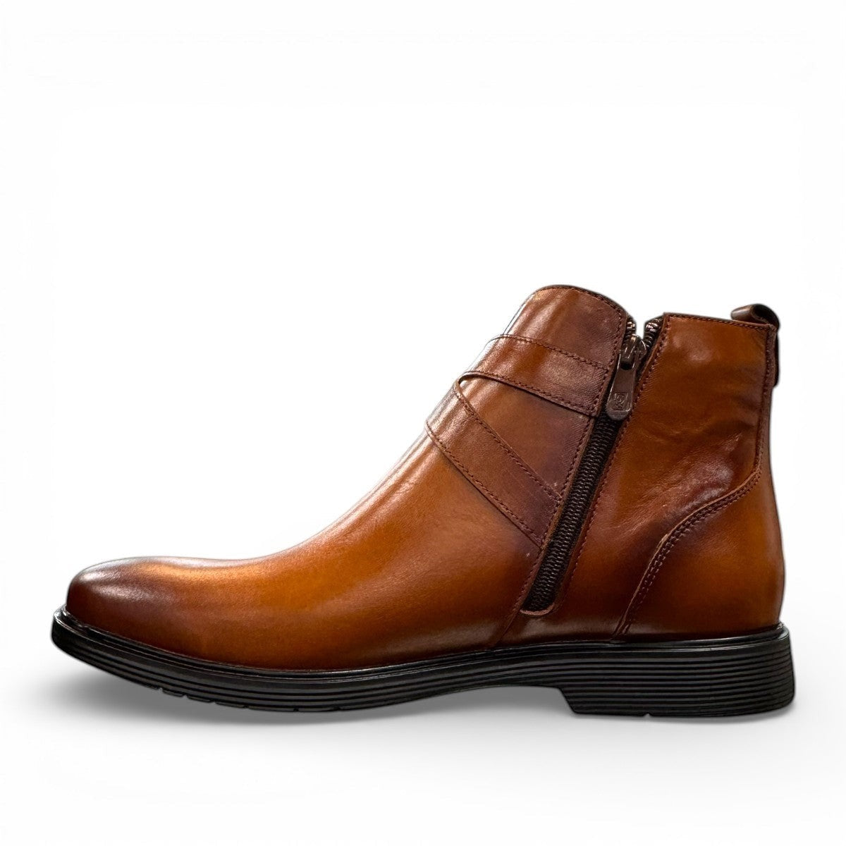 Brown leather ankle boots with a side buckle strap and durable rubber sole for formal wear. Photo of inside side view.