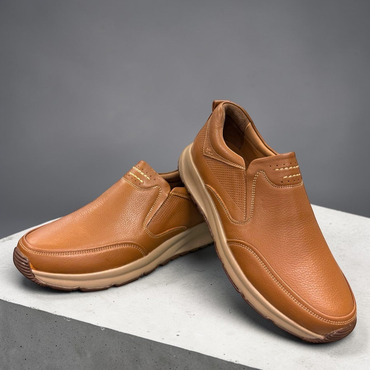 Atropat Kaya brown leather slip-on shoes with textured upper, rubber sole, and handmade stitching. Photo of front view.