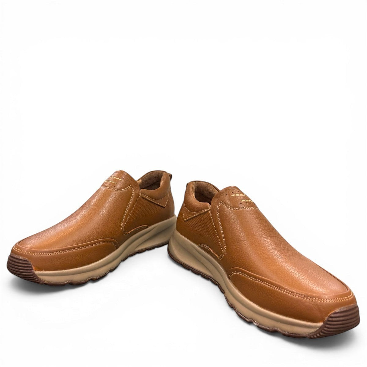 Atropat Kaya brown leather slip-on shoes with textured upper, rubber sole, and handmade stitching. Photo of front view at an angle.