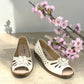 COLLEXION-F7067M white peep-toe comfort flats with floral detail, side perforations, and a flexible brown sole.
photo of the front side