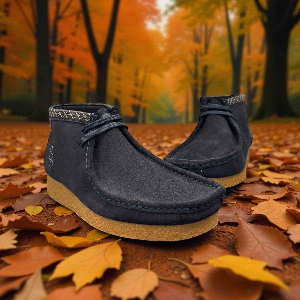 Sina Footwear blue leather Shacre boots with Wallabee-inspired design and rubber sole on an autumn leaf background. Photo at a front angle.
