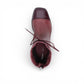 Django & Juliette burgundy leather ankle boots with a black patent square toe, block heel, and lace detail. top view