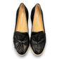 DJANGO & JULIETTE black leather platform loafers with a sporty rubber wedge sole and bow detail. Photo of upper view.