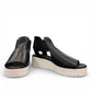 Django & Juliette Ozie black leather wedge sandal with elastic straps and a white platform sole. Photo of front view.