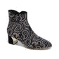Django & Juliette black suede ankle boots with rhinestone paisley patterns and metallic block heels. Photo of front side view.