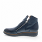 DJANGO & JULIET navy leather ankle boots with asymmetrical front zip, rounded toe, and low wedge heel. Photo of left side view.