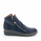 DJANGO & JULIET navy leather ankle boots with asymmetrical front zip, rounded toe, and low wedge heel. Photo of right side view.