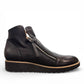 DJANGO & JULIET OHMY black leather ankle boot with asymmetrical front zipper and low wedge heel. Photo of right side view.