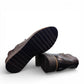 DJANGO & JULIET OHMY black leather ankle boot with asymmetrical front zipper and low wedge heel. Photo of bottom view.