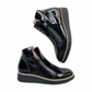 DJANGO & JULIET black patent leather ankle boots with asymmetrical front zip and low wedge heel. Photo of outter view.