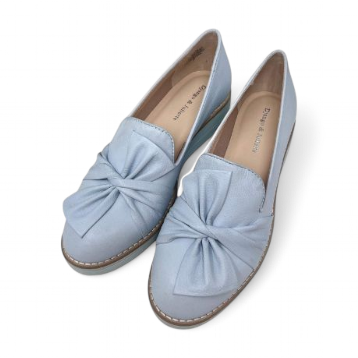 DJANGO & JULIETTE pale blue leather platform loafers with a bow detail and sporty rubber wedge sole. Photo of upper view.