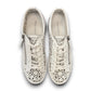 Django & Juliette Leitha white leather platform sneakers with laser-cut floral patterns and side zipper. Photo of upper view.