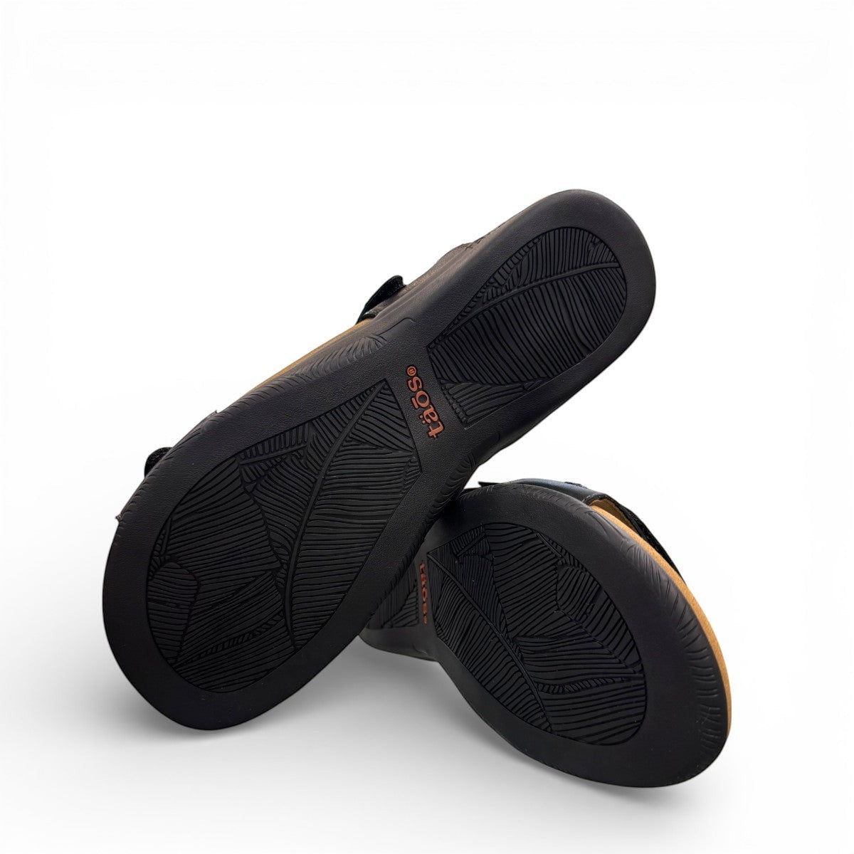 Taos Double U black leather slide sandal with adjustable hook and loop straps and cushioned foot bed. Photo of bottom view.