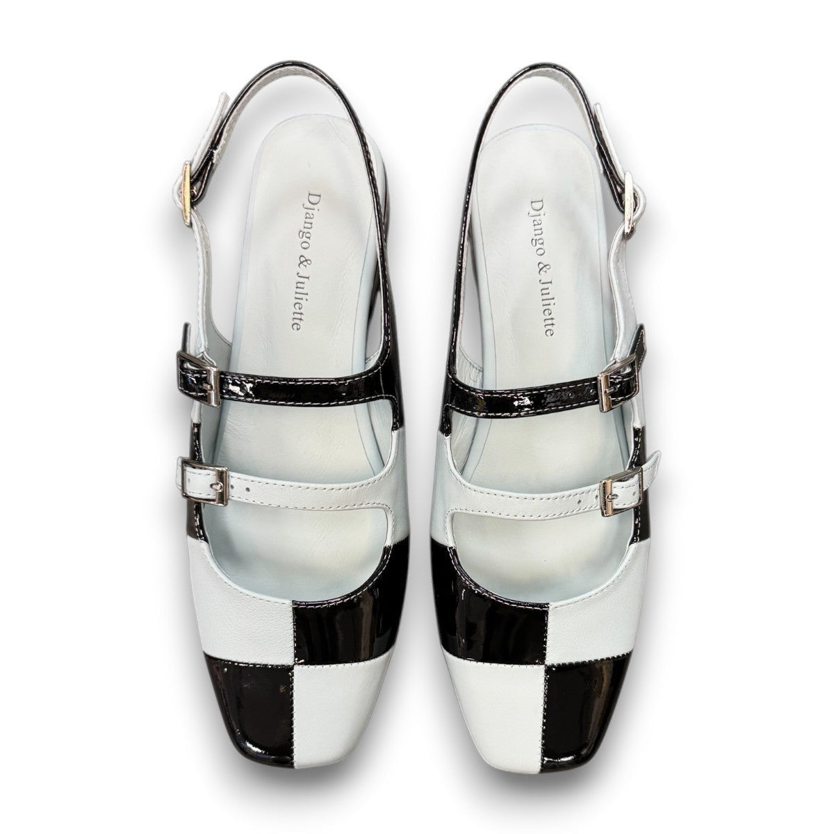 DJANGO & JULIETTE Brynns black and white patent leather slingback Mary Jane flat with buckled straps. top view.