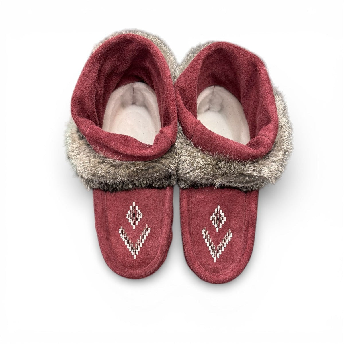 Laurentian Chief Nuka bordeaux suede moccasin with fur trim, beaded details, and black crepe sole.