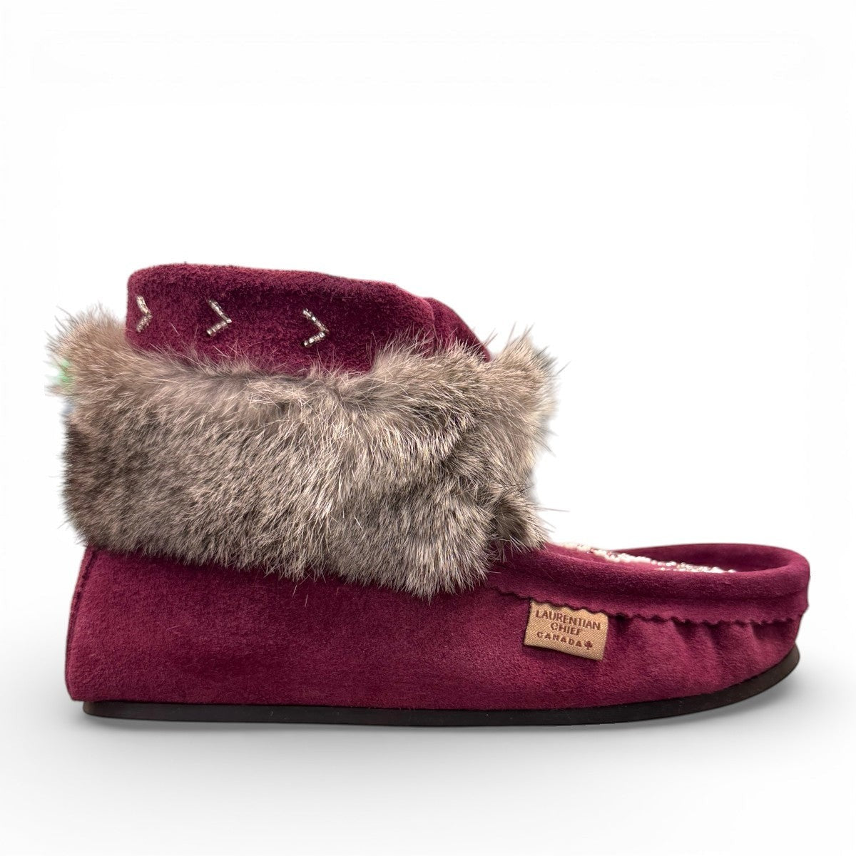 Laurentian Chief Nuka bordeaux suede moccasin with fur trim, beaded details, and black crepe sole.